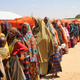 Displaced Somali women stand in line to receive food handouts on March 27, 2017. Image via AP Photo.